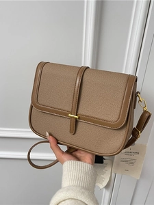 Vintage brown canvas crossbody bag with leather trim and gold buckle for women