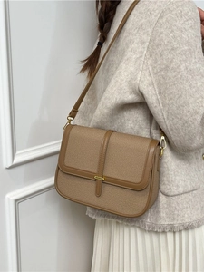 Retro canvas and leather crossbody bag shown on model with elegant styling