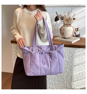 Détail du sac cabas matelassé violet avec poches latérales et cordon de serrage