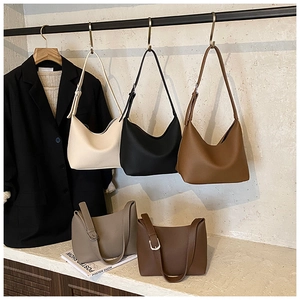 Detailed view of large crescent tote bags in five colors with smooth leather texture