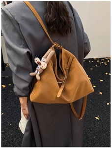 Brown faux leather tote bag with geometric pleats and cute plush rabbit charm