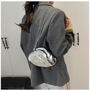Futuristic silver liquid mirror acrylic bag with chain strap on suit jacket