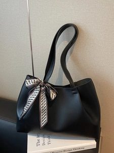 Minimalist black faux leather tote bag with elegant H-pattern silk scarf decoration