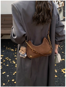 Brown suede hobo bag with gold chain strap and cute bear pendant for autumn fashion