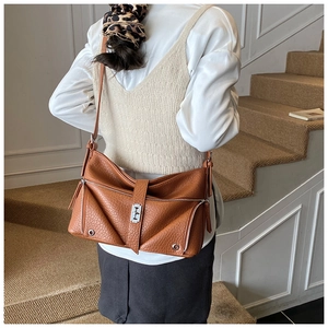 Detailed back view of a brown retro tote bag shown on a model in a minimalist setting