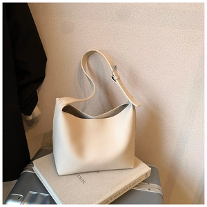 Detail of soft cream litchi grain leather hobo bag with adjustable silver buckle strap