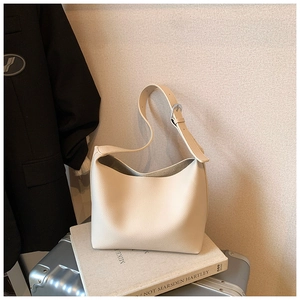 Detail of off-white lychee texture tote bag with adjustable silver buckle strap