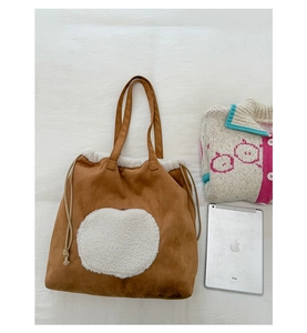 Top view of brown suede tote bag with plush shearling trim and drawstring detail