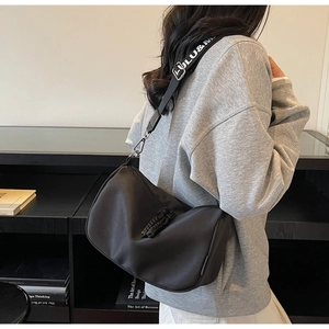 Detail of black nylon half-moon crossbody bag with wide letter print shoulder strap