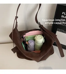Overhead view showing spacious interior of brown shoulder bag with daily essentials