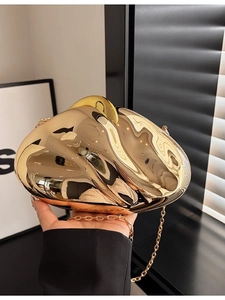 Irregular shell-shaped evening clutch bag in mirror gold finish with chain strap