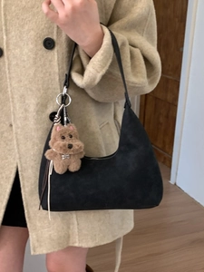 Bolso hobo de ante negro con forma de media luna y un lindo colgante de osito