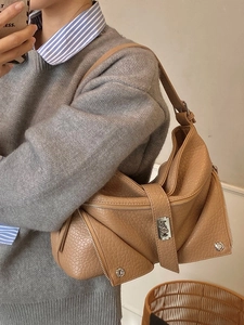 Vintage camel leather tote bag with lychee texture and decorative zippers on model