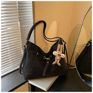 Detail of black matte leather Hobo bag with golden buckle and plush rabbit charm