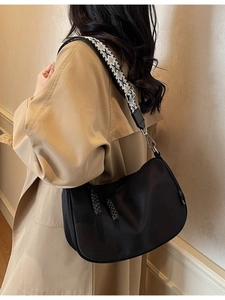 Fashionable black half-moon canvas crossbody bag with ethnic patterned wide strap