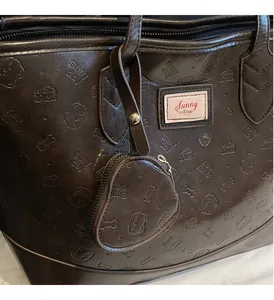 Detail of dark brown tote bag with cartoon embossing and a heart-shaped coin purse