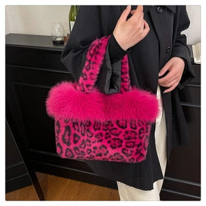 Detailed macro view of the plush fuchsia leopard print faux fur texture and handbag handle