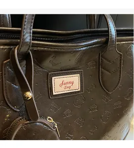 Detailed macro of dark brown embossed tote bag with glossy finish and red brand label