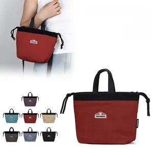 Detail view of the nylon crossbody bag with adjustable drawstring and red-black color block