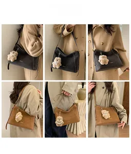 Detail view of vintage shoulder bags in black and brown with cute bear charms