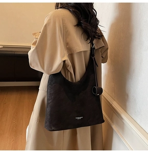 Detailed texture of black suede shoulder bag featuring FASHION & BAGS LEATHER print