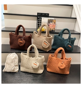 Detailed close-up of knitted tote bags in five colors with handmade circular coin purses