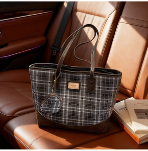 Grey checkered tote bag with heart pattern and mini pouch on leather car seat