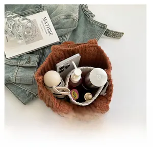 Interior view showing the large storage capacity of the brown knitted tote bag