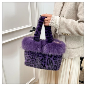 Detailed view of the purple leopard print faux fur handbag with soft plush handle