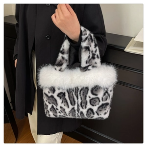 Close-up of fluffy leopard print handbag featuring plush faux fur trim and elegant texture