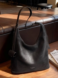 Minimalist black matte leather hobo bag with adjustable strap for commuting and daily use