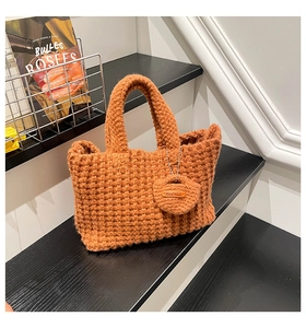 Close-up of caramel crochet tote bag with textured knit pattern and Hand Made tag