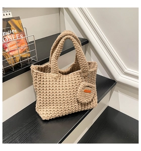 Detail of oatmeal knit tote bag with matching coin purse on minimalist display