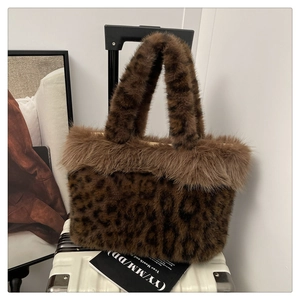 Detail of plush leopard print handbag on suitcase, showing soft faux fur texture
