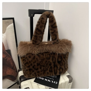 Close-up of leopard print faux fur handbag with fluffy plush trim and warm winter texture