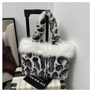 Detail of leopard print plush tote bag with fluffy white faux fur trim and soft handles