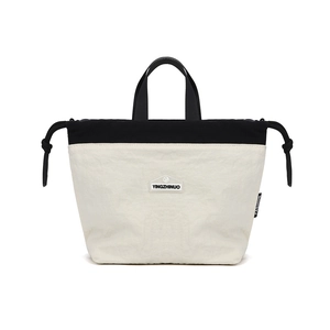 Close-up of contrast nylon tote with YINGZHINUO logo patch and fashion ribbon detail