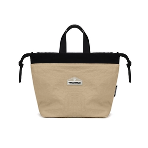 Close-up of nylon crossbody bag with drawstring closure and two-tone拼接 design
