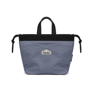 Close-up of lightweight nylon crossbody bag with drawstring design and blue contrast texture
