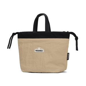 Detail of the drawstring closure and durable khaki nylon fabric on the crossbody bag