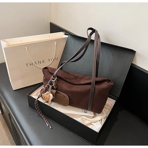 Deep brown matte leather shoulder bag with creative charm in premium gift packaging