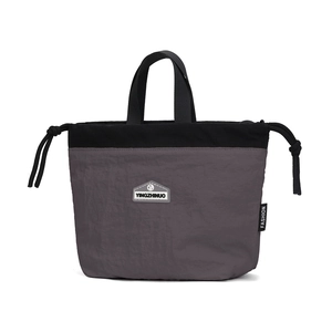 Detail of waterproof nylon drawstring handbag with grey color-blocking and brand logo