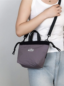 Lightweight nylon crossbody phone bag in purple and black with drawstring closure