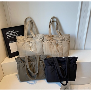 Quilted nylon tote bags in beige, khaki, grey, and black colors for winter travel