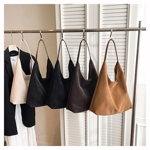 Detail view of five minimalist microfiber leather tote bags in various neutral colors
