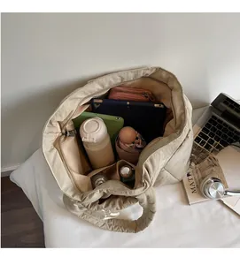 Top view of large nylon tote bag showing spacious interior with tablet and water bottle