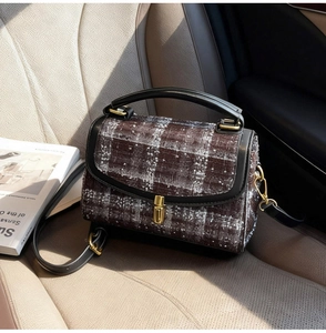 Classic checkered tweed bag with golden twist lock on a premium beige leather car seat