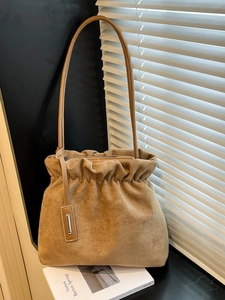 French style khaki suede bucket bag with pleated closure and elegant shoulder strap