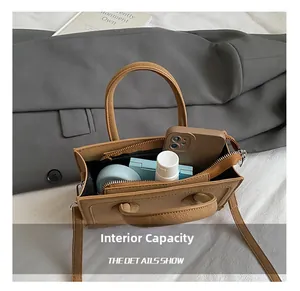 Interior view showing the capacity of a brown matte leather bag for phone and lipstick