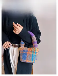 Detail of soft plush checkered bucket bag in vibrant blue, orange and purple faux fur
